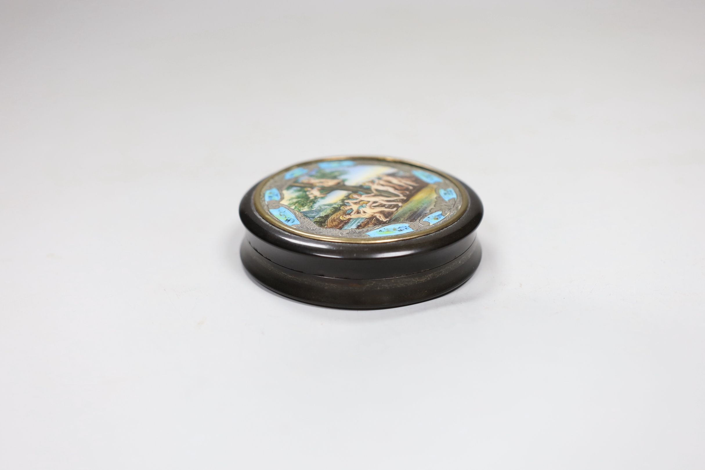 A 19th century circular tortoiseshell box, with ornate enamel and white metal cover, 8cm diameter